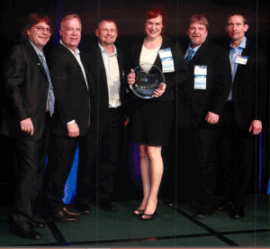 Jim Schnepper GAF Executive VP, Sales,  and Paul Bromfield GAF Senior VP, Marketing, present the 2013 President's Club Award to Chad Muth, Ty Lang, Holly Colley and Kelly Wengerd on behalf of Muth & Company Roofing.