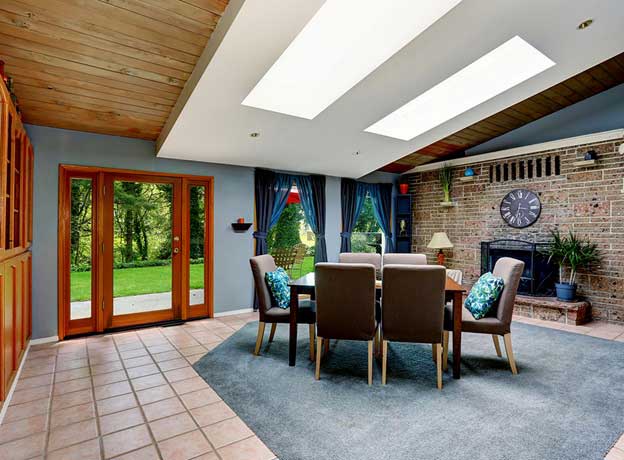 A home with a bright living space with skylights. Let the Sun Shine in This Winter with Skylights