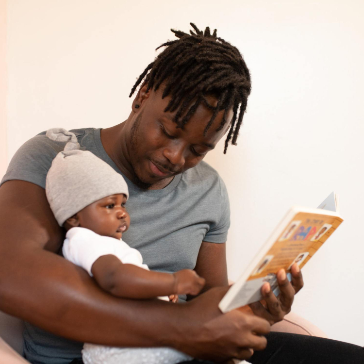 parent reading a book to a baby