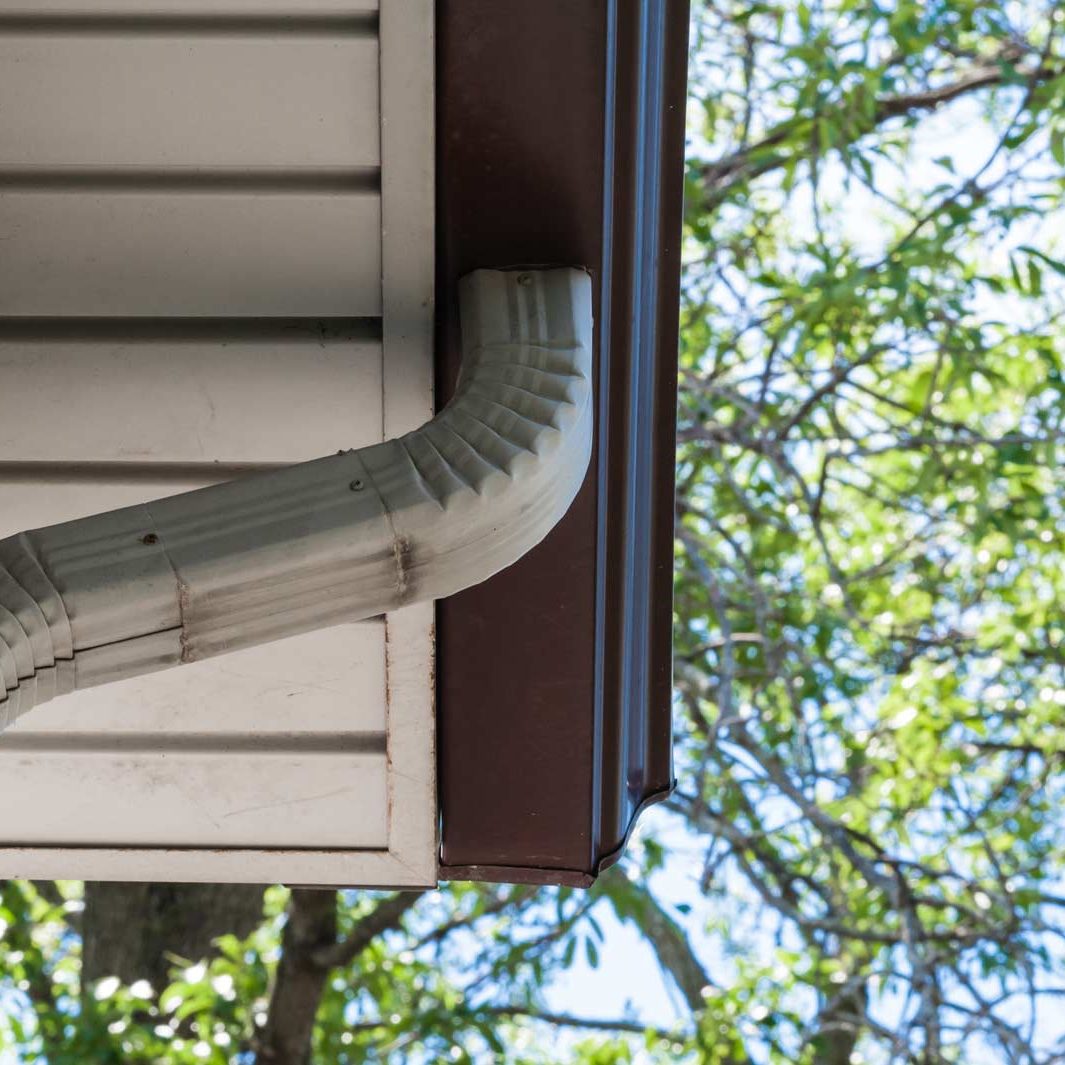 Gray Downspout pipe leading down from eavestrough